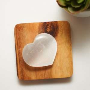 Selenite Heart on the wood plate