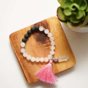 Rose Quartz Bracelet finished with Lava Beads on a wooden plate